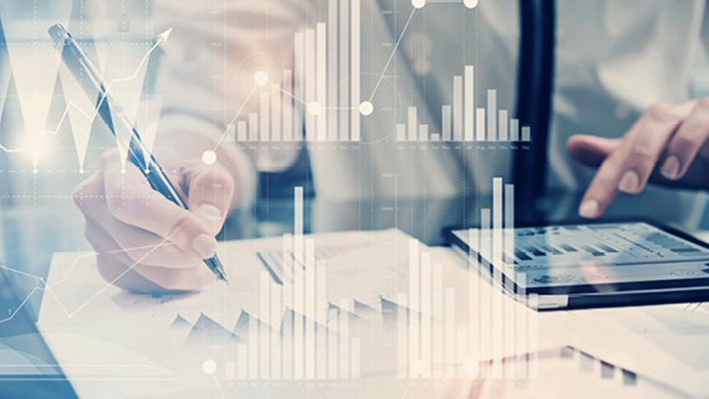 A person uses a tablet to plot financial charts.