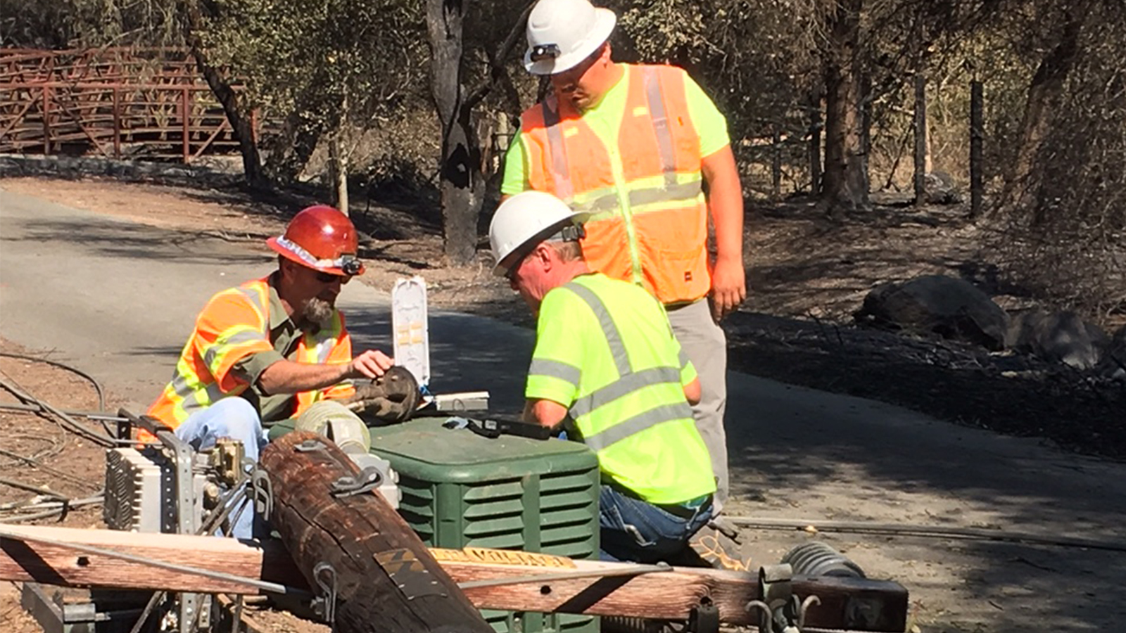 Xfinity technicians and linemen examining equipment.